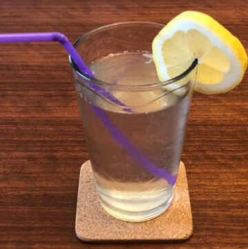 Glass of lemonade and lemon garnish