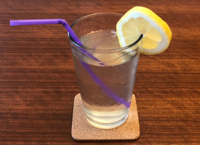 Glass of lemonade and lemon garnish