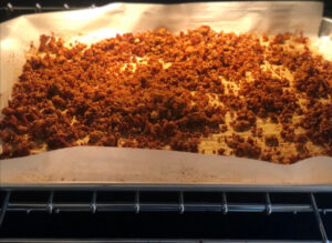 Baking sheet in oven with cooked tofu