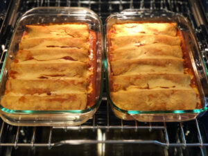 baked enchiladas topped with plant based cheese sauce
