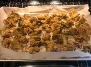 Roasted Brussels sprouts halves on parchment paper out of oven