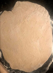 Pizza dough rolled by rolling pin