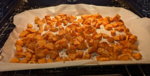 Sweet potatoes in the oven on parchment papaer