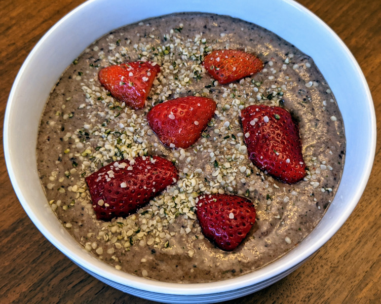 Oatmeal smoothie bowl with strawberries and hemp seeds as topings