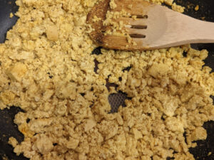 Tofu mixed with spices and scrambled in a pan